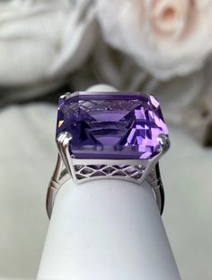 Natural Purple Amethyst RingE-Ring Design#D1 This is a beautiful vintage reproduction ring. The sterling silver filigree holds an ~20 carat natural purple amethyst gemstone. The amethyst stone has perfect purple grape color and amazing clarity. The flawless high quality square-cut gemstone is 18mm square. The stone and setting rise about 1/2" off the finger. The inside of the band is marked 925 for sterling silver. Notice the beautiful crisscross basket pattern in the silver filigree setting. Th Grape Color, Basket Pattern, Purple Grapes, Sterling Silver Filigree, Square Cut, Art Deco Ring, February Birth Stone, Silver Filigree, Amethyst Stone