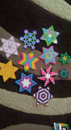 there are many different colored beads on the blanket that is made to look like stars