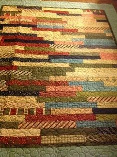 a close up of a quilt on a bed