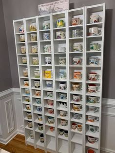 a large white bookcase filled with lots of shelves