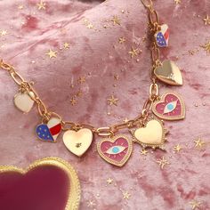 Immerse yourself in the eccentric charm of the Heart Evil Eye Charm Necklace, a standout piece from our "Powerful and Unconstrained Style" collection, straight out of a scene from a whimsical period piece. Picture this: an exquisite heart-shaped pendant, rendered in 18K gold-plated brass, is adorned with a bewitching evil eye motif. The necklace is meticulously detailed with a cascade of dripping oil and a sprinkling of cubic zirconia, adding a dash of cinematic sparkle. This charm necklace is n Heart-shaped Dangling Charms Jewelry For Valentine's Day, Heart-shaped Jewelry With Dangling Charms For Valentine's Day, Symbolic Heart-shaped Charms Jewelry, Symbolic Heart-shaped Jewelry With Charms, Valentine's Day Symbolic Heart-shaped Jewelry, Gold Necklaces With Dangling Charms For Valentine's Day, Valentine's Day Heart Charm Dangle Necklace, Valentine's Day Symbolic Necklaces With Heart Pendant, Valentine's Day Dangle Heart Charm Necklace