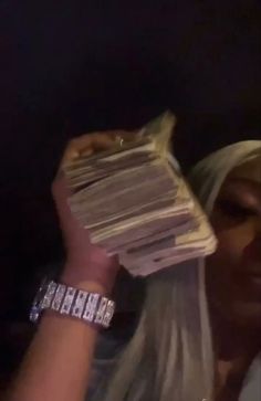 a woman holding up stacks of papers in her hands