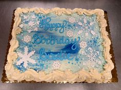 a birthday cake with frosting and snowflakes on it