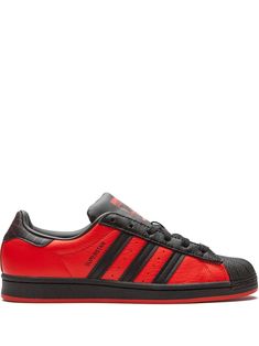 red/black leather/rubber round toe flat rubber sole front lace-up fastening branded insole signature three-stripe logo These styles are supplied by a premium sneaker marketplace. Stocking only the most sought-after footwear, they source and curate some of the most hard to find sneakers from around the world. Adidas Superstar Supercolor, Dc Skate Shoes, Adidas Black Sneakers, Adidas Superstar Black, Adidas Super, Vintage Trainers, Adidas Superstars, Adidas Shoes Mens, Adidas Sneakers Women