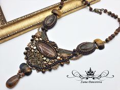 the necklace is adorned with beads and stones