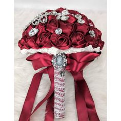 a bridal bouquet with red roses and jewels