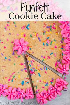 a cake with pink frosting and sprinkles is cut into pieces to make it