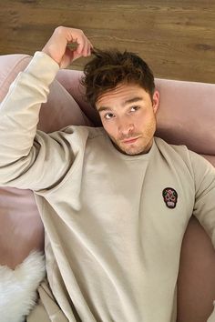 a man laying on top of a pink couch