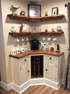 a corner kitchen with shelves and cups on the counter