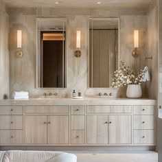 a large bathroom with two sinks and mirrors