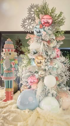 a white christmas tree with ornaments and decorations