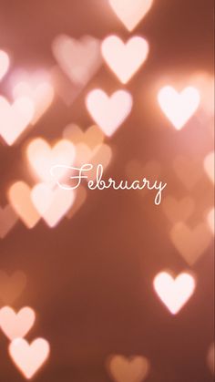 a blurry photo of hearts with the word february written in white on it's left side