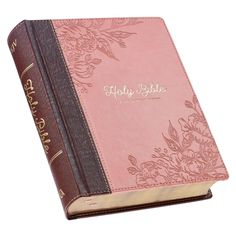 a pink and brown bible with gold lettering on the front cover is opened to show it's name