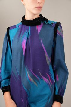 Bold 1980s wool dress with striking velvet details on the collar and cuffs. The dynamic abstract print in rich shades of blue, purple, and magenta captures the essence of 80s power dressing. Its high neckline with button accents adds a touch of sophistication to this eye-catching piece. The dress is in good vintage condition, with a few small holes in the fabric (see photos for details).  The size is not indicated, but the dress fits like about a size M (EU 38, IT 42, UK 10). I am 175cm (5.9ft) Power Dressing, 80s Vintage, Wool Dress, Vintage Wool, High Neckline, Dress Clothes For Women, Abstract Print, Shades Of Blue, Blue Purple