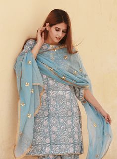 Cotton blue Printed Suit Set with Kotta Doriya Dupatta The set consists of printed kurta with gotta detailing on neck teamed with matching printed pajama and a kotta doriya dupatta with embroidery & gotta detailing Kurta Length-39 inches Palazzo Length-34 inches Dupatta Length-2.5 meters Work-Print Detailing Color-Blue Kurta Fabric-Cotton Bottom Fabric-Cotton Dupatta Fabric-Kotta Doriya Model Size- 5.8 tall wearing small size Sleeves - 3/4th Sleeves Neck-Round neck Washing Care-Hand wash or Dry Printed Pajama, Printed Suit, Blue Kurta, Cotton Dupatta, Cotton Bottoms, Print Pajamas, Suit Set, Embroidery Details, Fabric Cotton