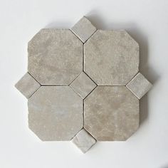 a white marble tile with hexagonal design on the top and bottom part, in various sizes