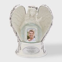 an angel figurine is shown in the shape of a vase with a photo on it