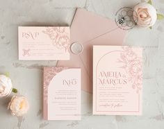 the wedding stationery is laid out on top of an envelope and some pink flowers