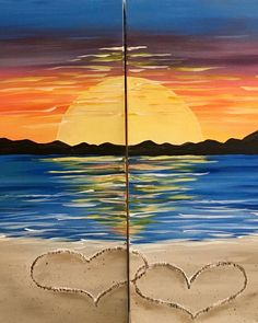 two hearts drawn in the sand on a beach at sunset with mountains and water behind them