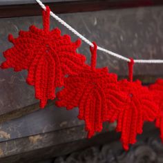 red knitted leaves hanging from a string