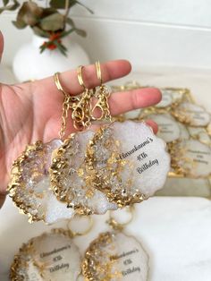 a person holding three pieces of jewelry in their hand