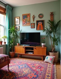 a living room filled with furniture and lots of plants on top of the tv stand