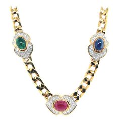 A Magnificent 14.50 Carat Natural Colorless Round Brilliant Diamond, Ruby, Sapphire and Emerald Cabochon necklace set in 18k Yellow Gold. The piece is set with 48 colorless Round Brilliant diamonds weighing a total of 4.20 Carats, VS in clarity. The 2.50 carat Natural Green Emerald Cabochon measures 9.9x7x4.5mm. The 4.20 carat Natural Red Ruby measures 9.7x7.3x5.5mm. The 3.60 carat Natural Blue Sapphire measures 9.7x7.2x4.8mm. Please note that all gradings are approximate. This is a pre-owned es Emerald Cabochon, Cabochon Necklace, Ruby Sapphire, Natural Blue Sapphire, Brilliant Diamond, Natural Red, Round Brilliant, Chains Necklace, Blue Sapphire