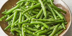 green beans in a bowl with salt and pepper sprinkled on the side, ready to be eaten