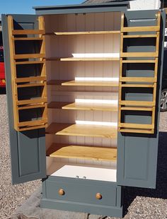 an open storage cabinet sitting on the side of a road