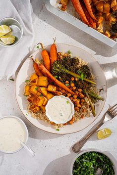 a white plate topped with carrots and other food