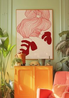 a living room with an orange chair and large painting on the wall above it's yellow cabinet