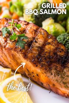 a close up of a plate of food with salmon and broccoli