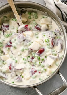 a pot full of food with peas and meat