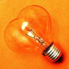 an orange light bulb sitting on top of a table