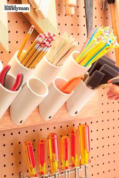 there are many different types of pencils in the holder on this pegboard,