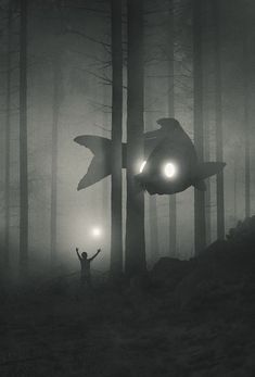 a man standing next to a giant shark in the forest with two lights on it's eyes