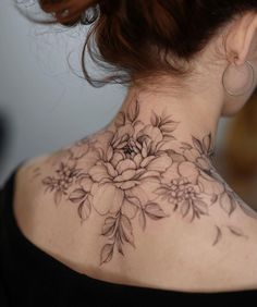 a woman with a flower tattoo on her neck