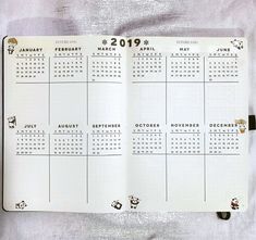 a planner is open to show the calendar on it's side, with stickers