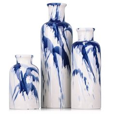 three blue and white vases sitting next to each other