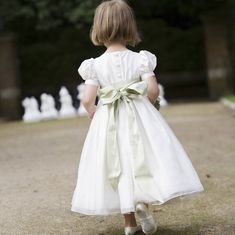 Ivory silk dupion dress with full gathered skirt, silk organza overskirt, short puffed sleeves, silk covered buttons, round neckline with silk piping and fully lined. A flowergirl in our enchanting silk Alice dress will feel like a perfect princess on your special wedding day. Little Bevan is about great British design with an understated elegant style, fresh appeal and precise fit, and with utmost thought and care given to designs, quality fabrics and finishing details. Styles are inspired by t Silk Flower Girl Dress, Silk Bridesmaid Dresses, Alice Dress, Cheap Flower Girl Dresses, Girls Dress Shop, Cheap Flowers, בר מצווה, Princess Ball Gowns, Trendy Flowers