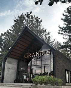 the entrance to a restaurant with trees in the background