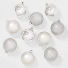 white and silver christmas ornaments on a white background