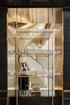 an art deco display case in gold and black