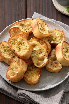 a plate filled with bread on top of a wooden table