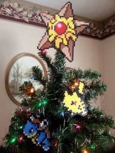 a decorated christmas tree with an ornament in the shape of pikachu