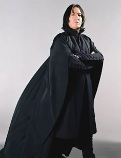 a man dressed as darth vader with his arms crossed and quote on the back