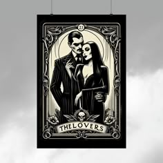 a poster hanging from the side of a building with a couple in front of it