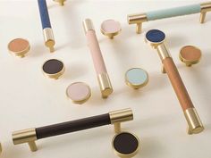 several different types of makeup brushes on a white surface with gold and blue handles, including one for eyeshades