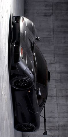 an aerial view of a car parked on the side of a building next to a parking meter