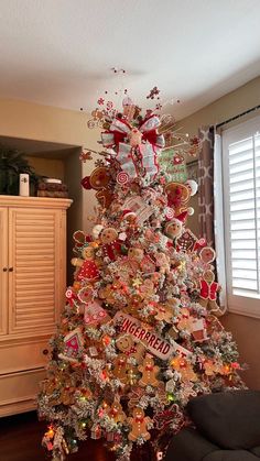 a decorated christmas tree in a living room with lots of candy on it's branches